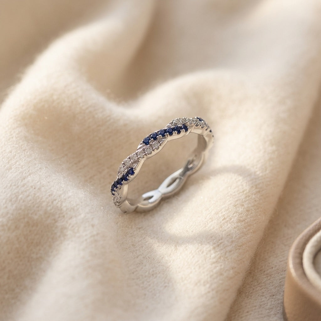 Sapphire and Diamond Twist Eternity Band in 18k White Gold — textile flat lay