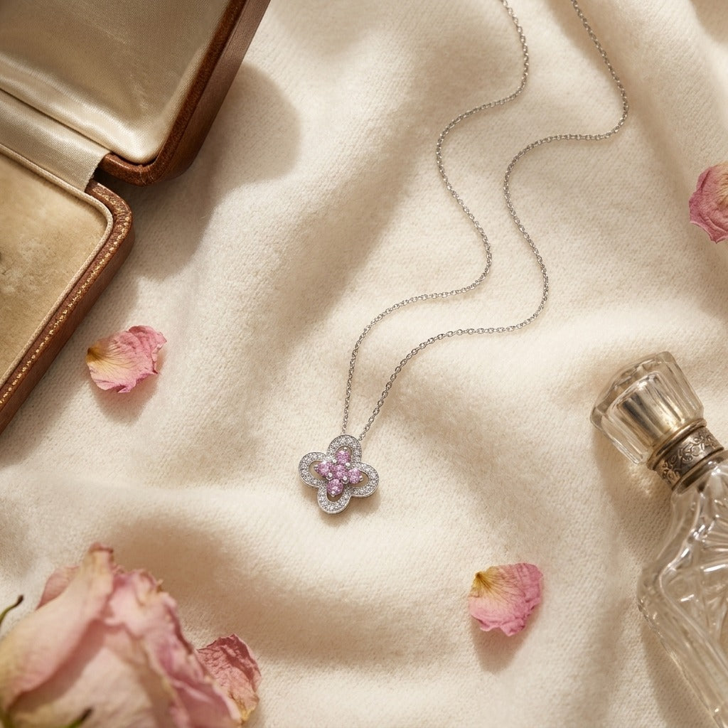 Pink Sapphire and Diamond Four-Petal Floral Necklace in 18k White Gold — textile flat lay