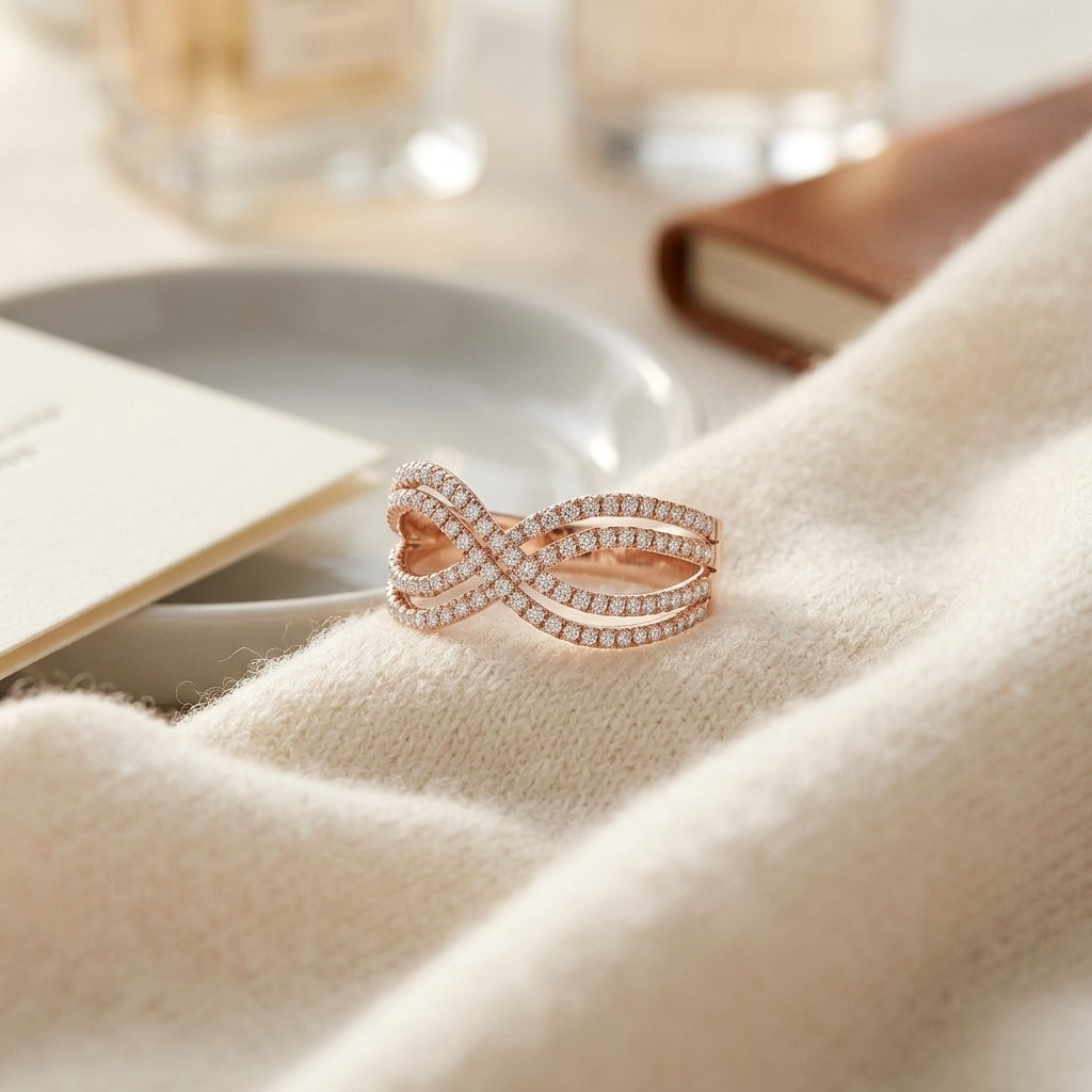 Diamond Infinity Twist Ring In 14k Rose Gold — textile flat lay