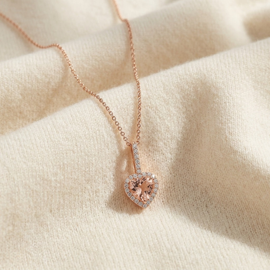 Morganite and Diamond Halo Heart Pendant in 14k Rose Gold 1/4ctw — textile flat lay