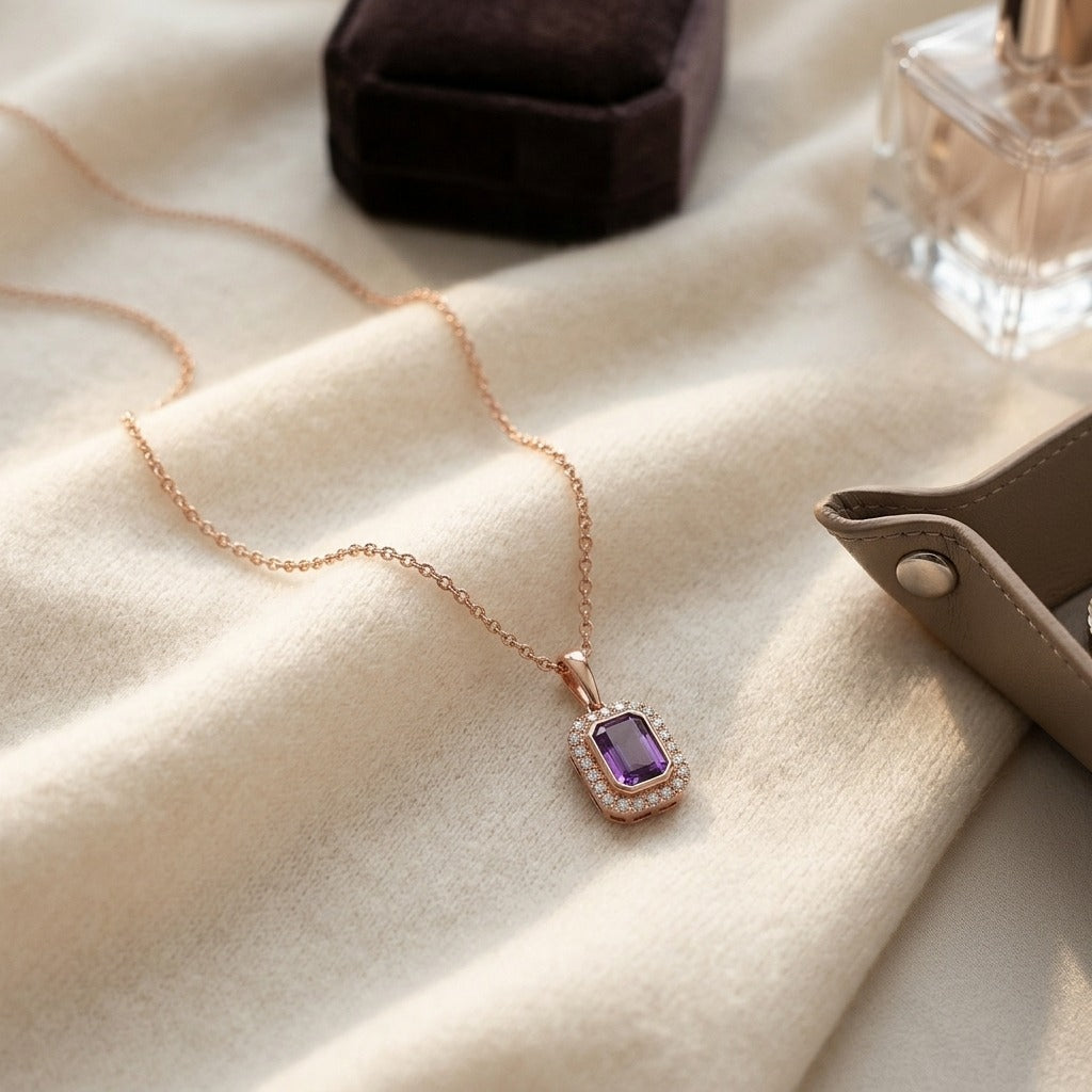 Amethyst and Diamond Bezel Pendant with Micro-Prong Frame and High Polish Tapered Bail in 14k Rose Gold (7x5mm) — textile flat lay