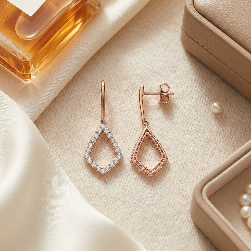 Diamond Kite Shape Drop Earrings in 14k Rose Gold — textile flat lay