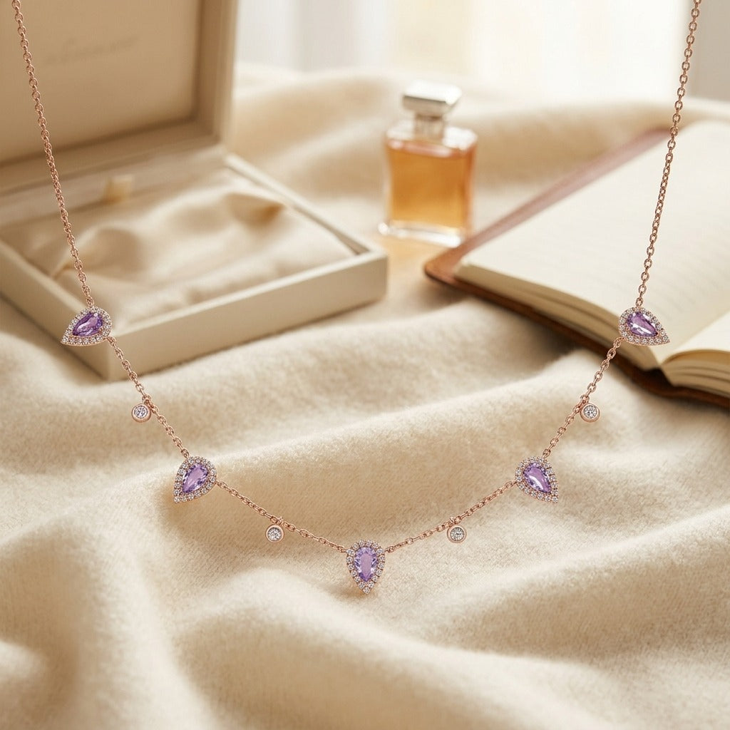 Amethyst and Diamond Teardrop Halo and Round Bezel Station Necklace in 14k Rose Gold (6x4mm) 16-18 Inch Adj Chain — textile flat lay