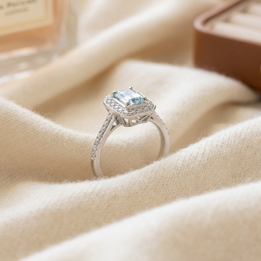 Aquamarine Emerald Cut Halo Ring In 14k White Gold — textile flat lay