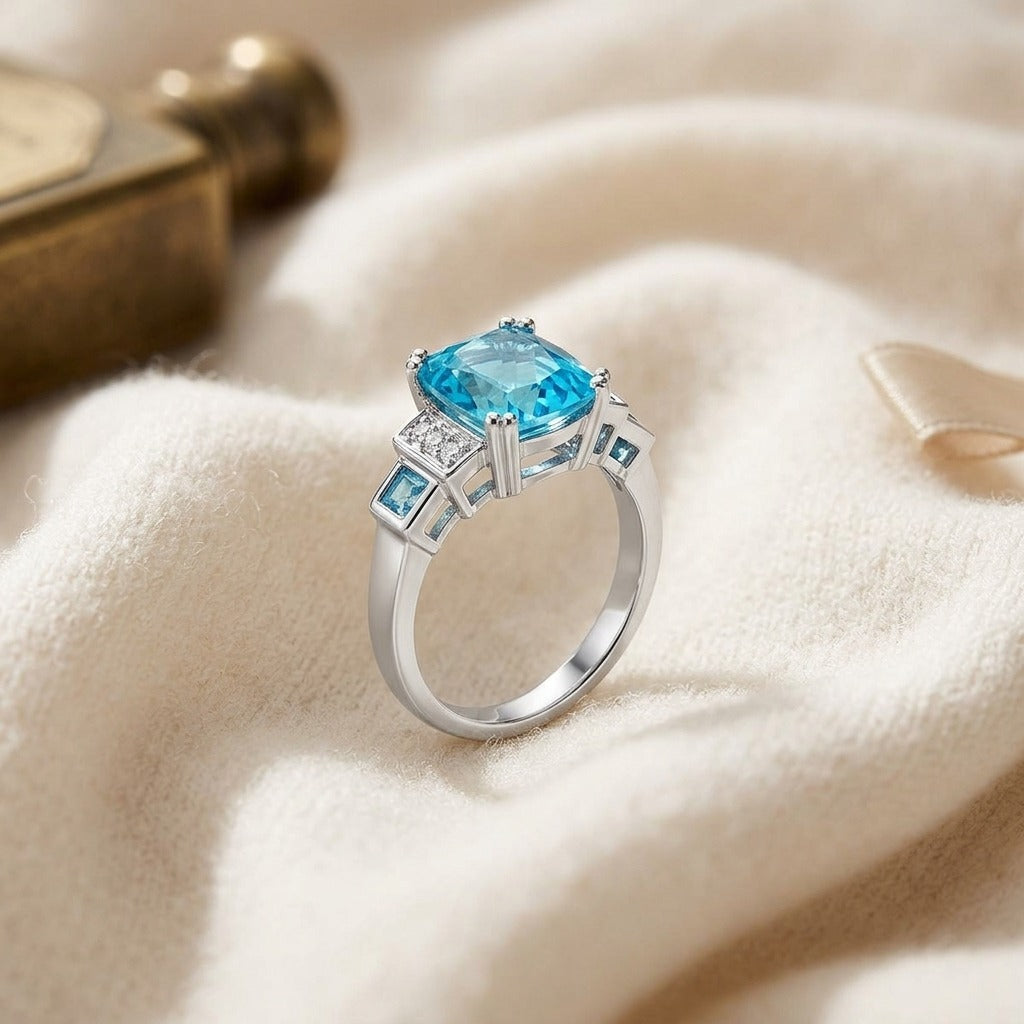 Swiss Blue Topaz and Diamond Step Ring 0.03ctw — textile flat lay