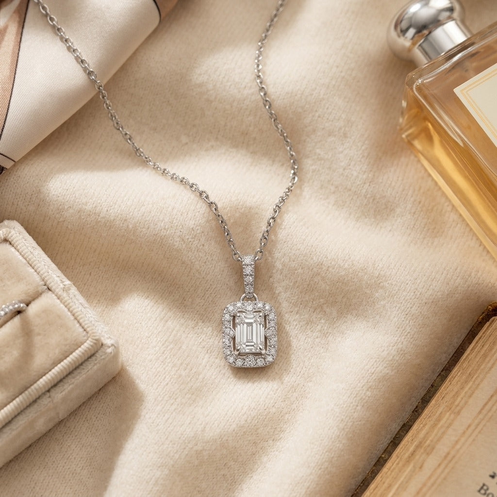Diamond Rectangular Halo Pendant in 14k White Gold 3/4ct Emerald Cut Center 9/10ctw 16-18 Inch Adj Chain — textile flat lay