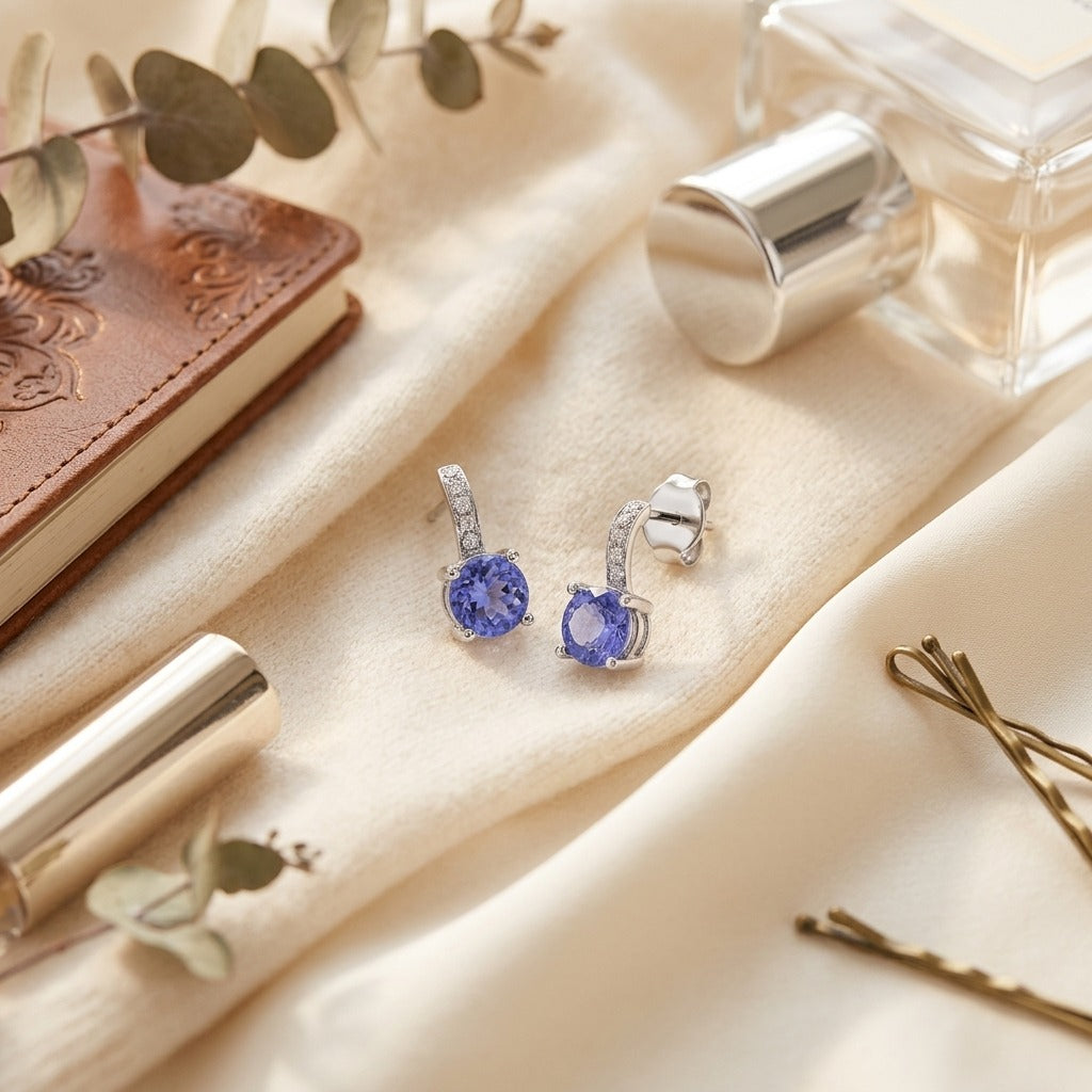 Tanzanite and Diamond Earrings in 14k White Gold — textile flat lay