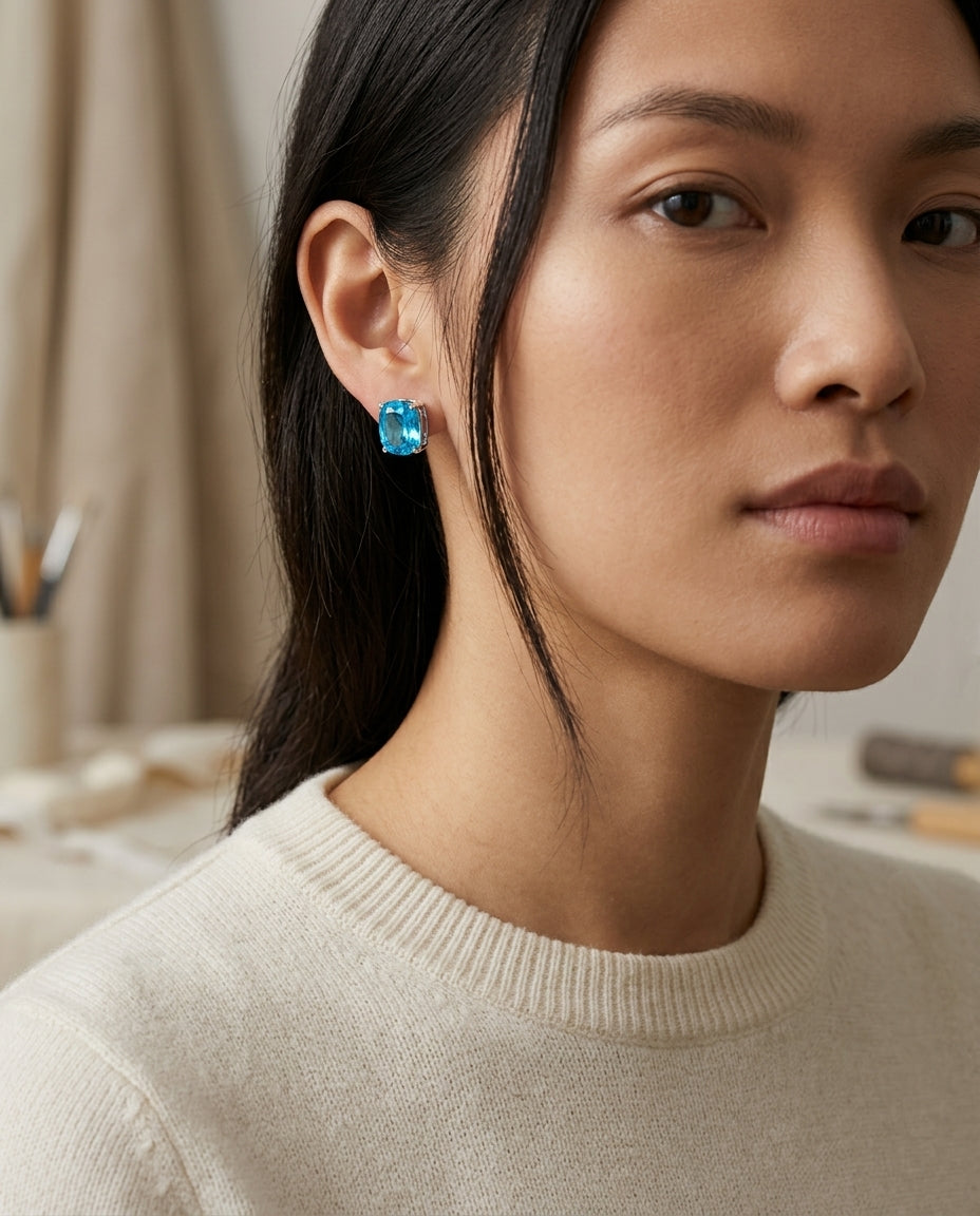Blue Topaz Cushion 4 Prong Stud Earrings In 14k White Gold — editorial close-up