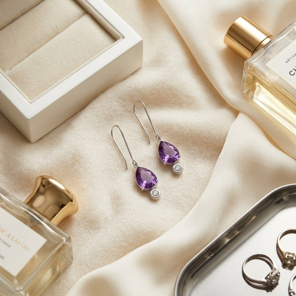 Amethyst and Bezel Diamond Teardrop Leverback Earrings in 14k White Gold 1/8ctw — textile flat lay