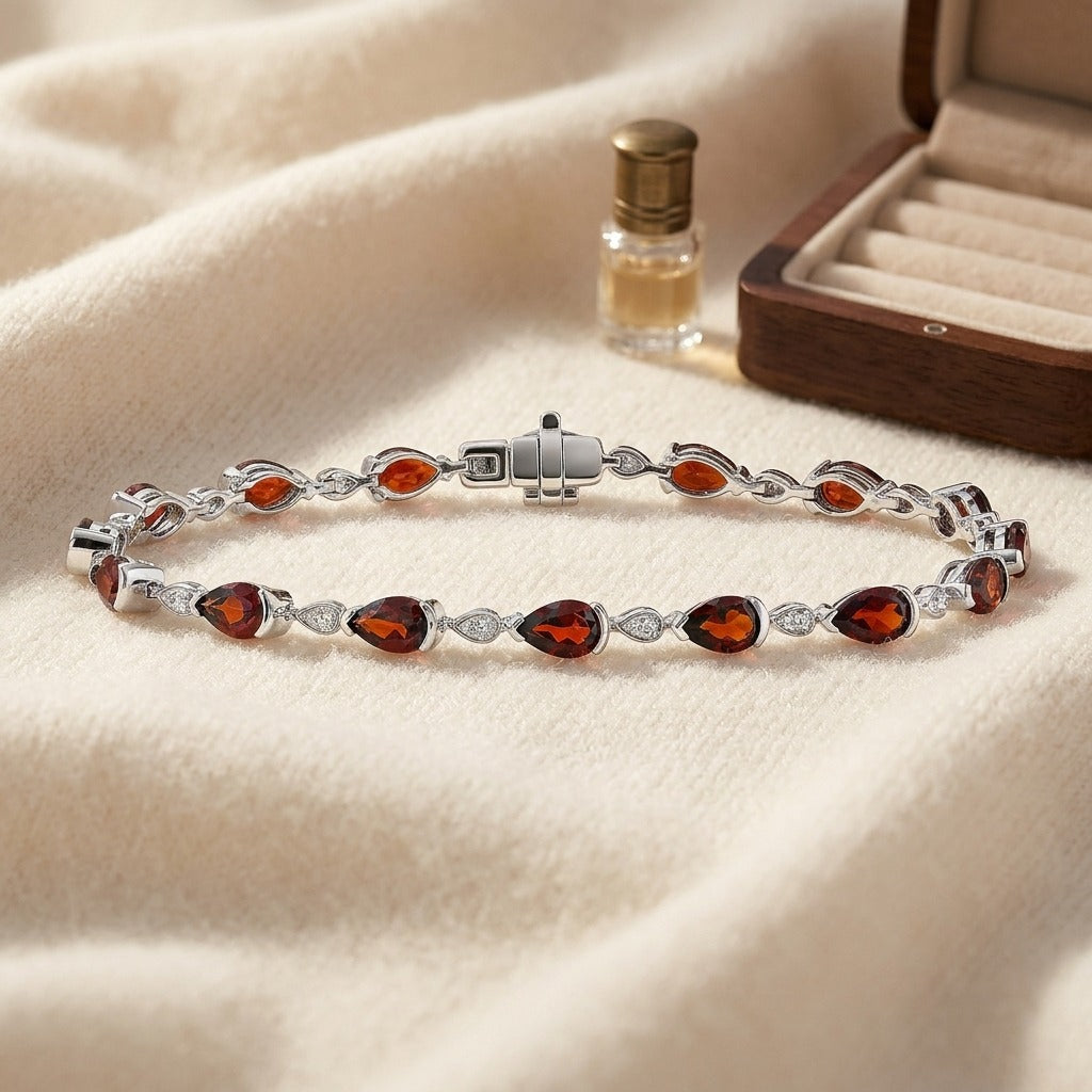 Garnet Pear-Shape and Diamond Pave East-West Bracelet in 14k White Gold (6x4mm) — textile flat lay