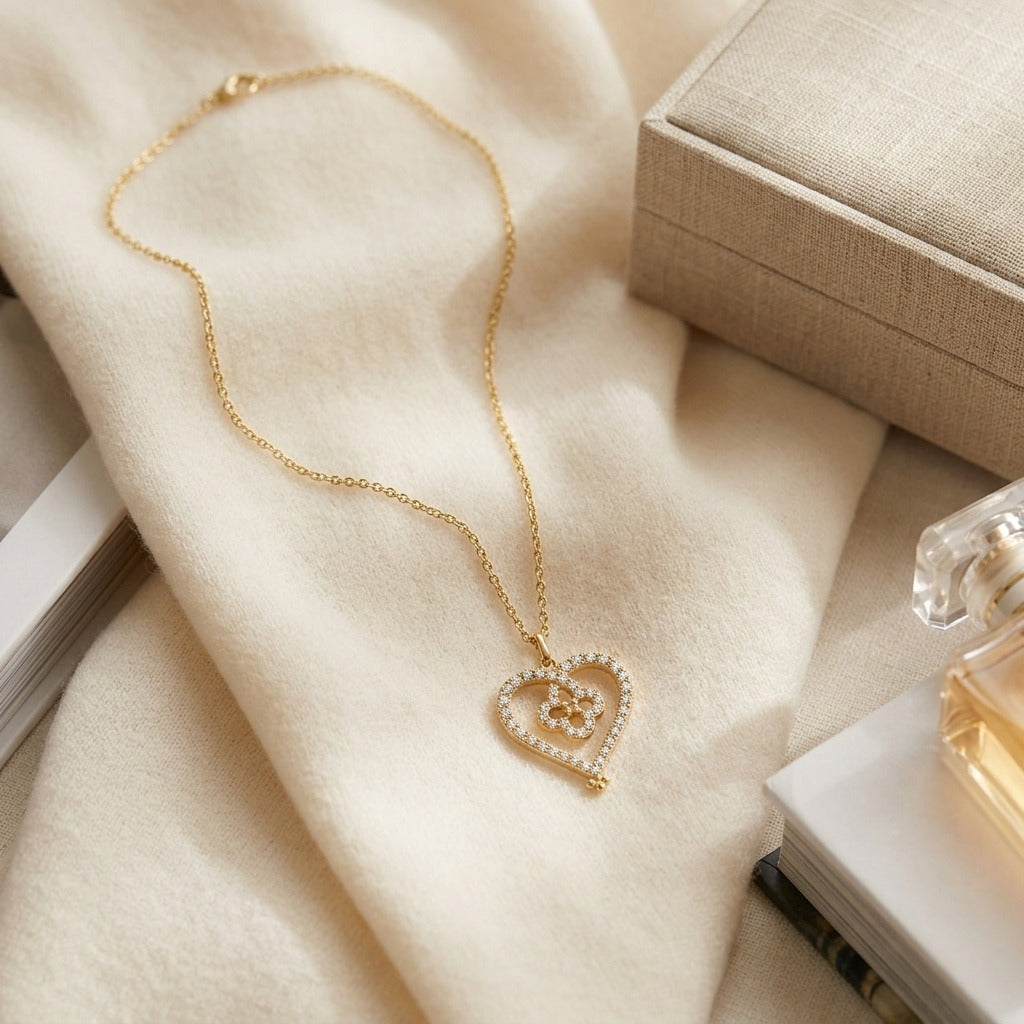 Diamond Pave Clover-in-Heart Pendant in 14k Yellow Gold — textile flat lay