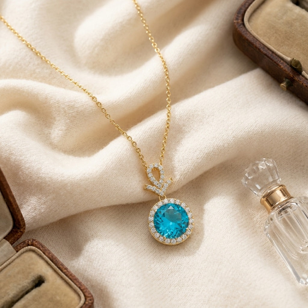 Blue Topaz and Diamond Pave Halo Pendant in 14k Yellow Gold — textile flat lay