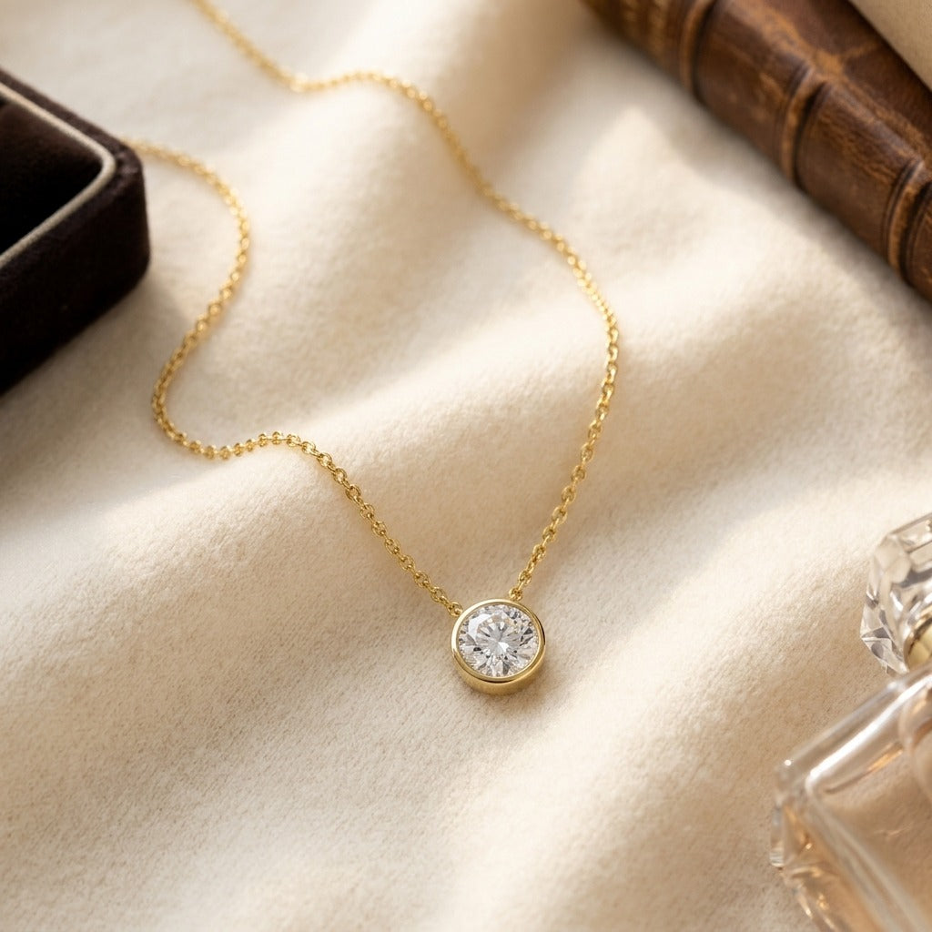 Round (Full Cut) Diamond Solitaire Pendant in a 14k Yellow Gold Bezel Slide Setting, 1ct. T.w. (J, Vs1) Gia with Paper Clip Chain — textile flat lay