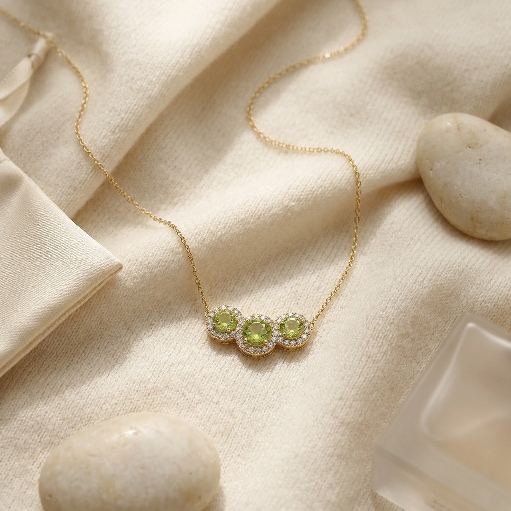 Peridot and Diamond Round Halo Trio Necklace in 14k Yellow Gold — textile flat lay