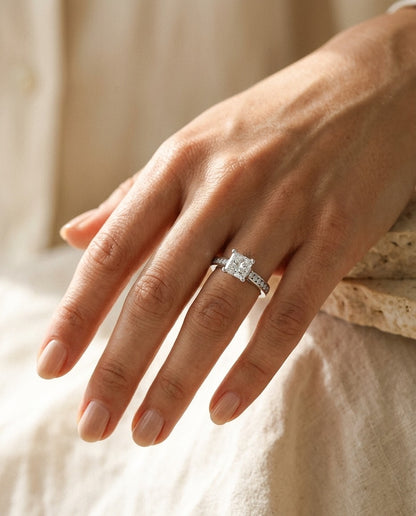 Diamond Princess Cut Center (0.69ct) Ring with Channel-Set Round Sides in 18k White Gold — portrait close