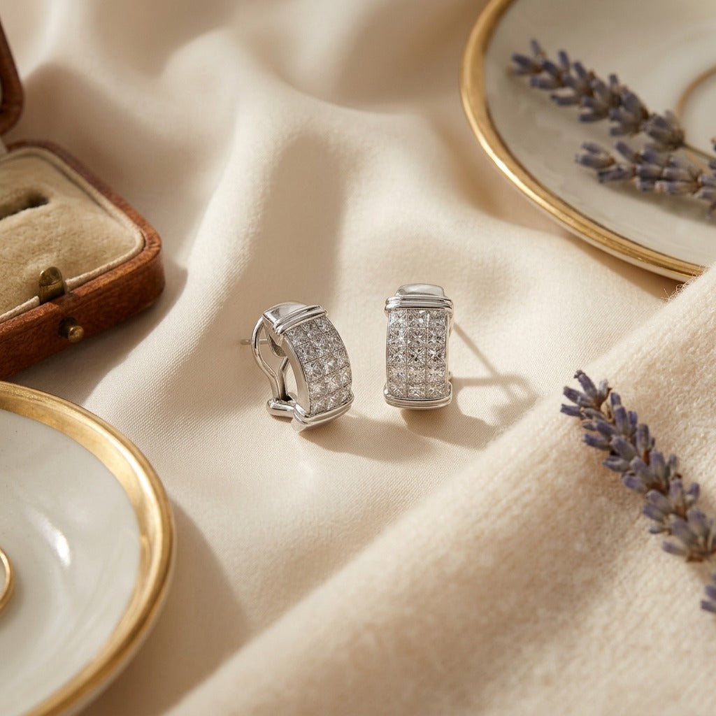 Invisible Set Diamond and Gold Omega Clip Earrings — textile flat lay