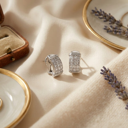 Invisible Set Diamond and Gold Omega Clip Earrings — textile flat lay