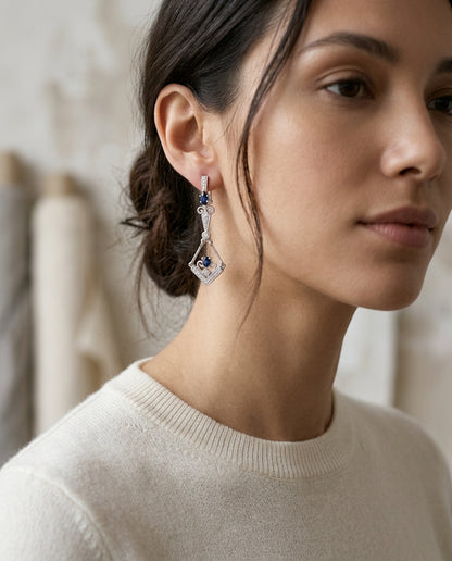 Sapphire And Diamond Dangle Kite Omega Back Earrings In 18k White Gold — editorial close-up