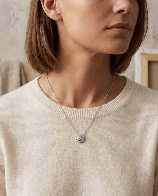 Diamond Round Bezel Halo Pendant With Milgrain In 18k White Gold — editorial close-up