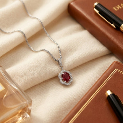 Ruby And Diamond Oval Scalloped Frame Pendant In 18k White Gold (18-in Foxtail Chain) — textile flat lay