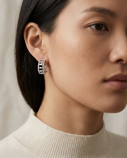 Diamond Baguette Open Step Omega Back Earrings In 18 Karat White Gold — editorial close-up