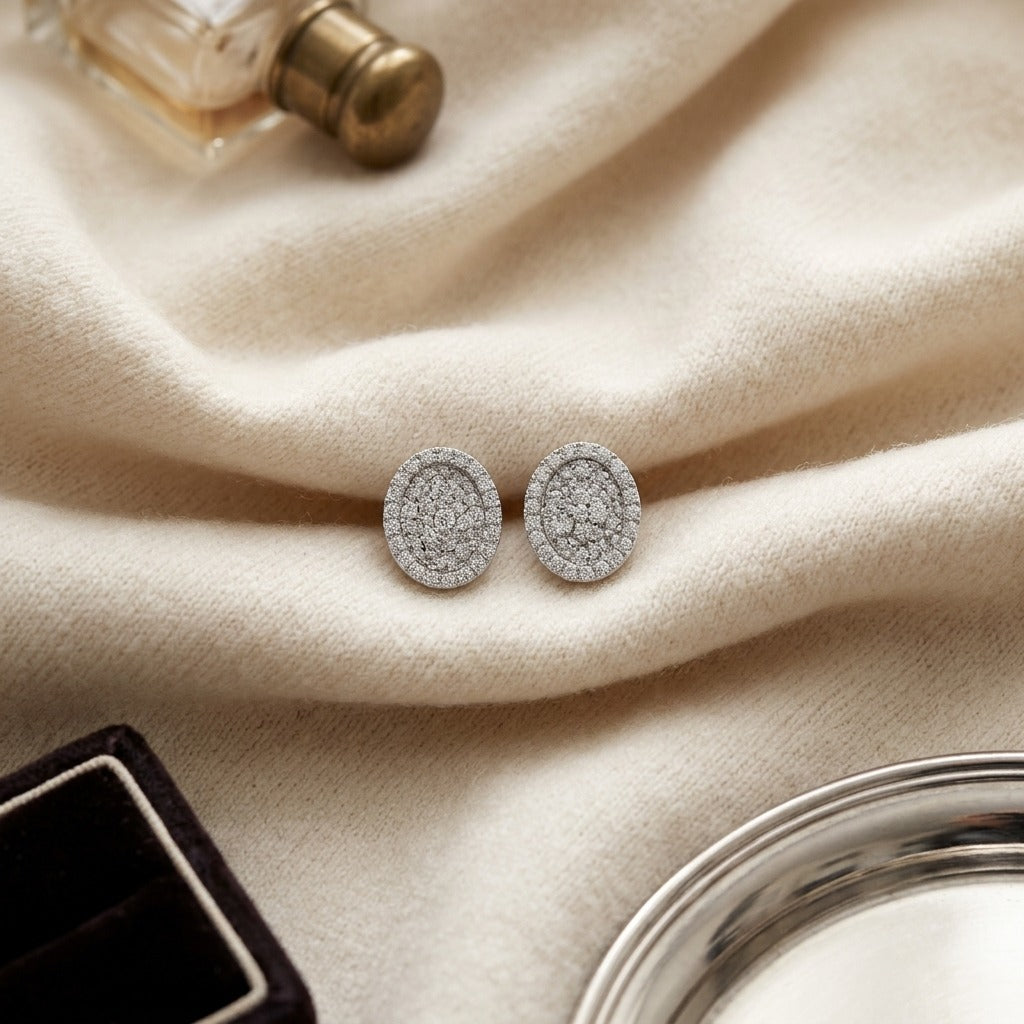 Diamond Pave Concave Oval Earrings In 18k White Gold 3/4ctw — textile flat lay