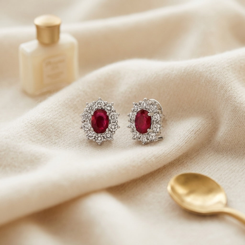 Ruby Oval Prong Halo Earrings In 18k White Gold 2Ctw — textile flat lay