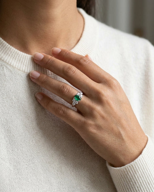 Emerald And Diamond Oval Prong Ring In 18k White Gold — editorial close-up
