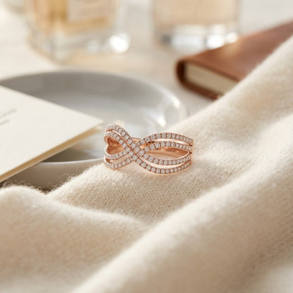 Diamond Infinity Twist Ring In 14k Rose Gold — textile flat lay