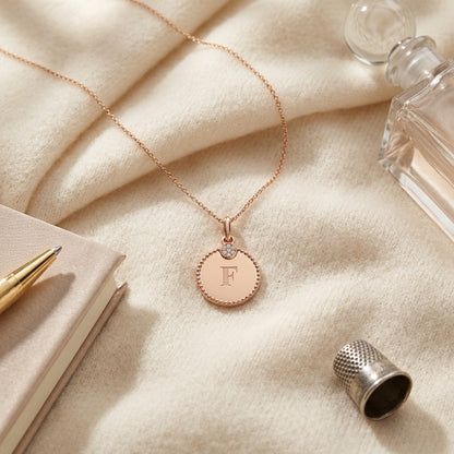 14k Gold Diamond Accent Initial Disc Pendant — textile flat lay