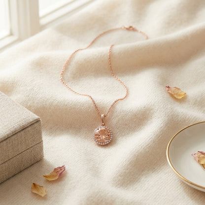 Morganite and Diamond Halo Pendant in 14k Rose Gold — textile flat lay