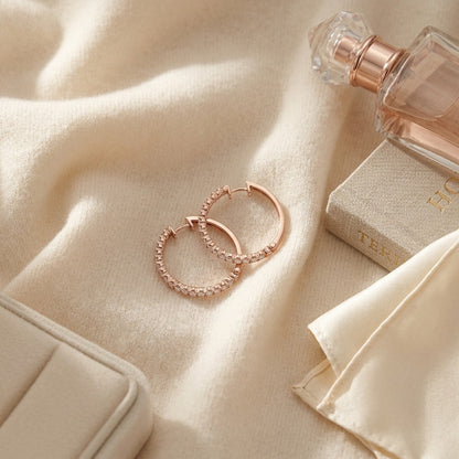 Diamond Micro Pave Hoops in 14k Rose Gold — textile flat lay