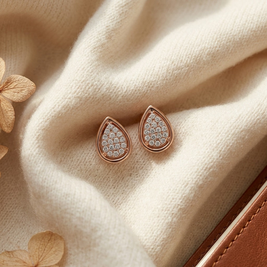 Diamond Pave Teardrop Cluster Earrings with High Polish Border in 14k Rose Gold — textile flat lay