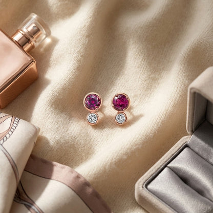 Rhodolite Garnet and Diamond Round Duo Earrings in 14k Rose Gold (4mm) (Si) — textile flat lay