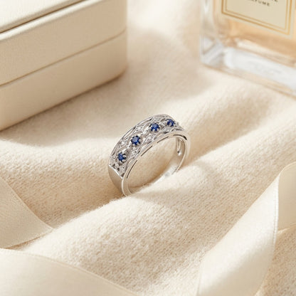 Sapphire and Diamond Triple Row Millgrain Ring in 14k White Gold — textile flat lay