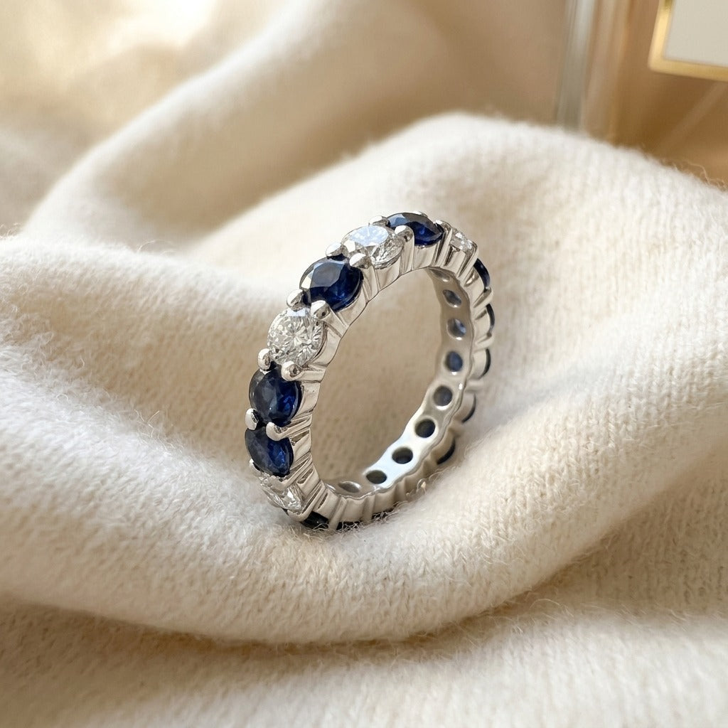 Custom Eternity Band in 14k White Gold with 14 Round Diamonds 1.87ctw and 7 Blue Sapphires 0.75ctw, Finger Size 7, Ckg Stock — textile flat lay