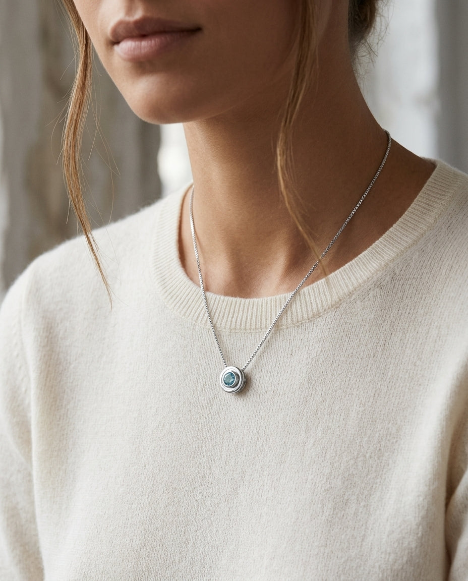 Blue Topaz Bezel Set In 14k White Gold Pendant — editorial close-up