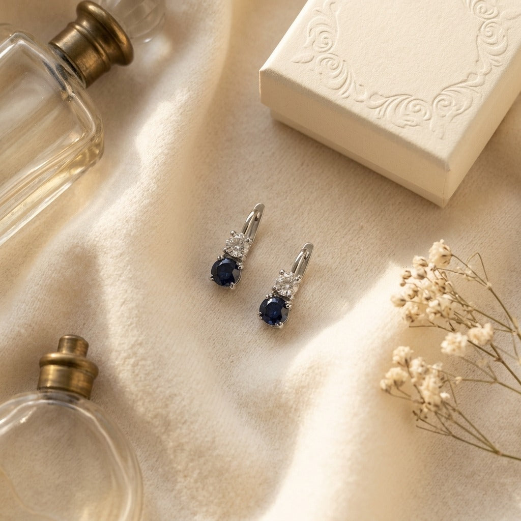 Sapphire And Diamond Two Stone Hinged Back Earrings In 14k White Gold — textile flat lay