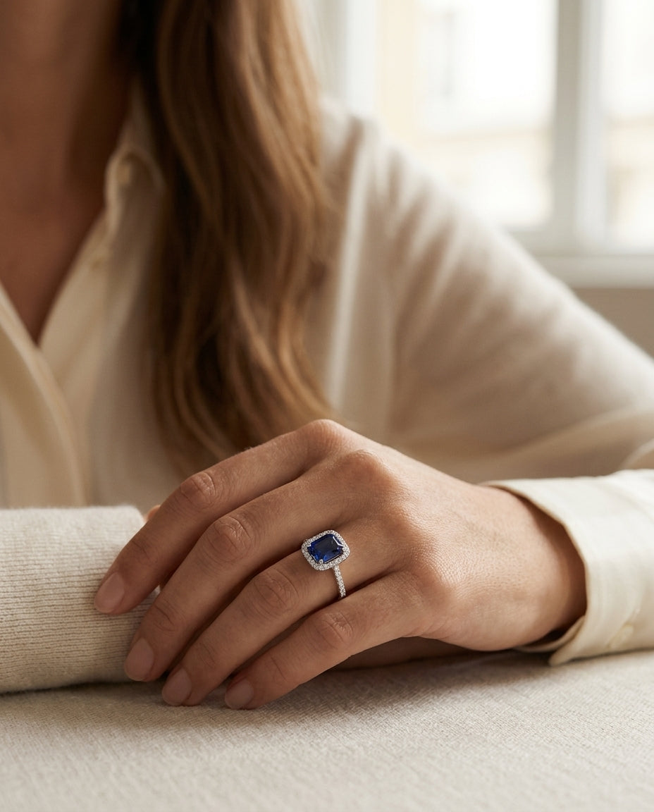 Emerald Cut Sapphire And Micropave Diamond Halo Ring In 14k White Gold — editorial close-up
