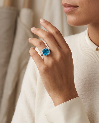 Blue Topaz Cushion Cut And Diamond Halo Ring  In 14k White Gold — editorial close-up