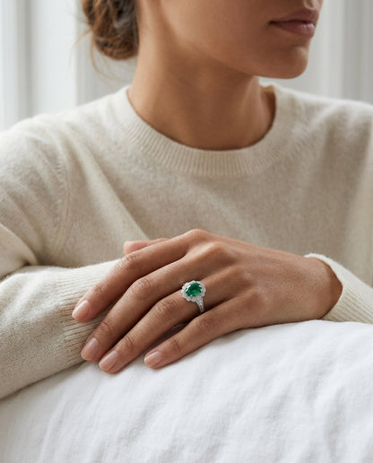 Emerald Oval And Diamond Halo Ring In 14k White Gold — editorial close-up