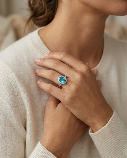 Blue Topaz And Diamond Oval Halo Split Shank Ring In 14k White Gold ( Hi / Si ) — editorial close-up