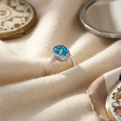 Blue Topaz and Diamond Pear Shape Halo Ring in 14k White Gold (9x6mm) — textile flat lay
