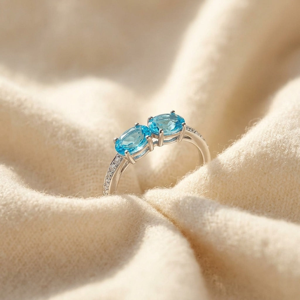 Blue Topaz Duet and Pave Diamond Shank in 14k White Gold — textile flat lay