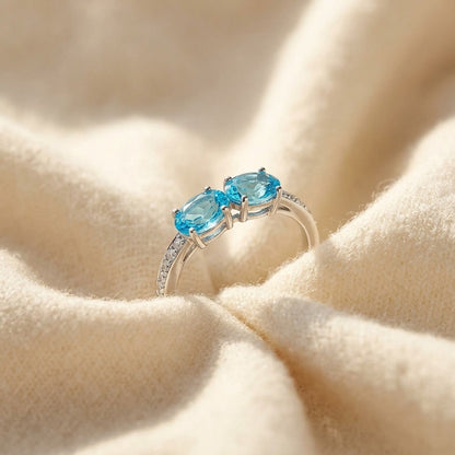 Blue Topaz Duet and Pave Diamond Shank in 14k White Gold — textile flat lay