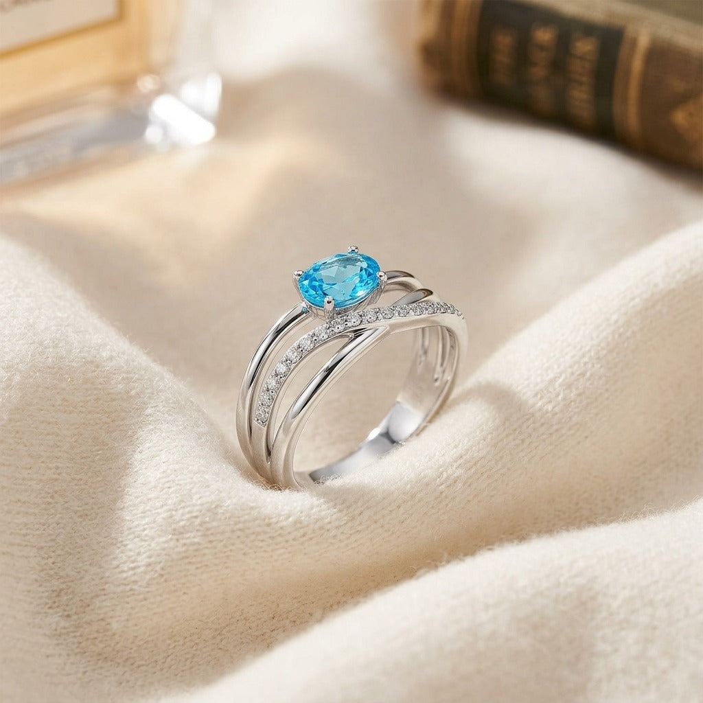 Blue Topaz and Diamond Pave Bypass Ring in 14k White Gold — textile flat lay
