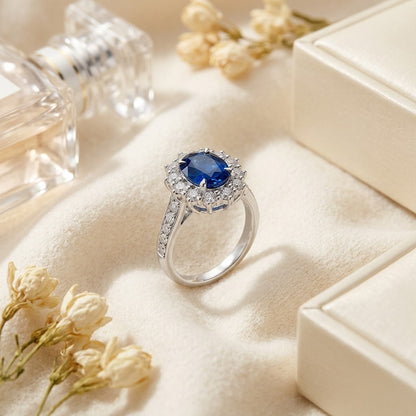 Sapphire and Diamond Oval Ring with Prong-Set Frame and Graduated Shank in 14k White Gold (8x6mm) — textile flat lay