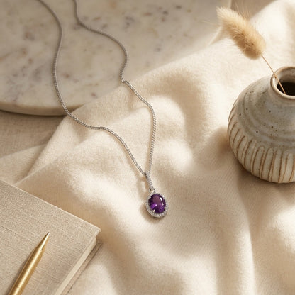 Amethyst and Diamond Oval Halo Pendant with Slim Bail in 14k White Gold (9x7mm Center) — textile flat lay