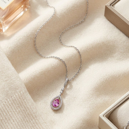 Pink Sapphire & Diamond Pendant — textile flat lay