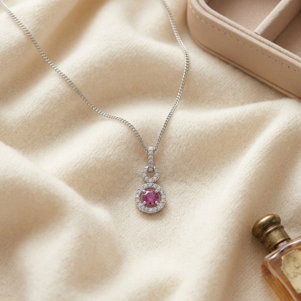 Pink Sapphire and Diamond Doorknocker Pendant in 14k White Gold (5mm Round Center) — textile flat lay